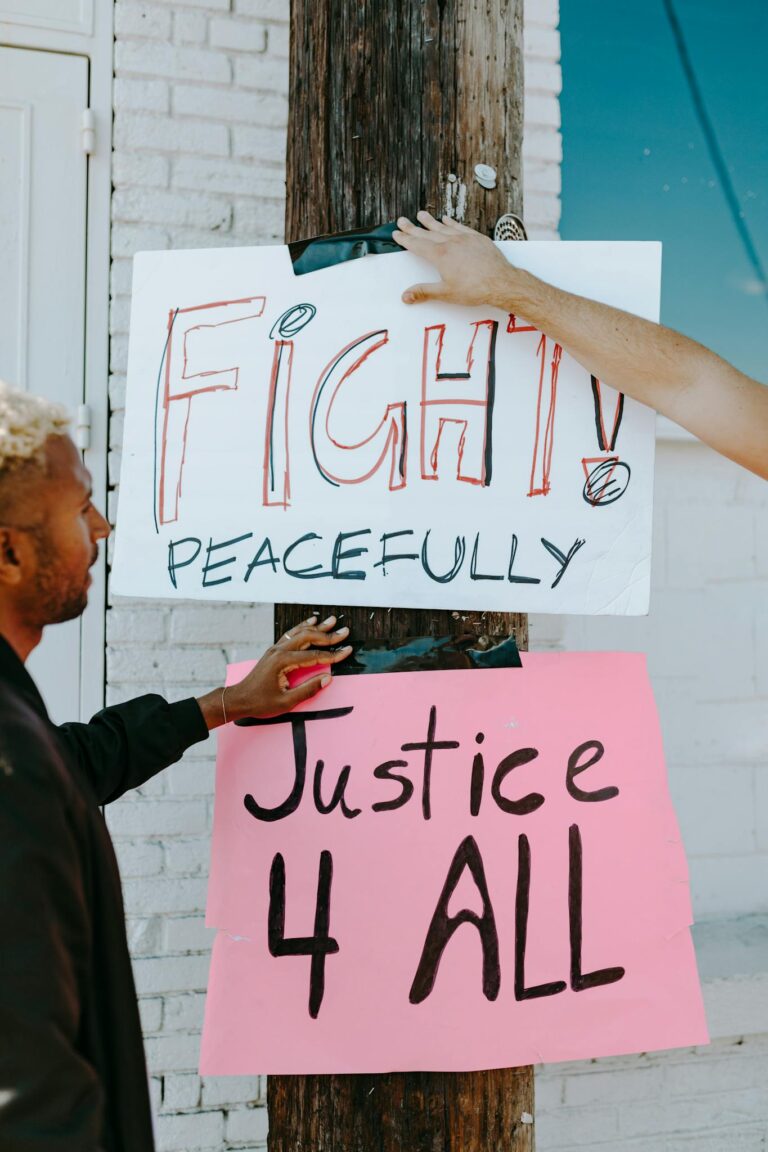 Protest signage with messages advocating for peaceful change and justice for all.