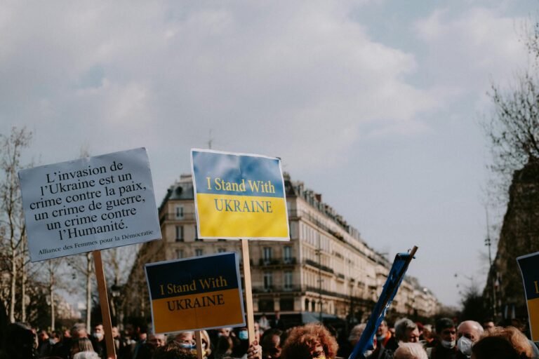 Protesters rally in the city holding signs supporting Ukraine and denouncing invasion.